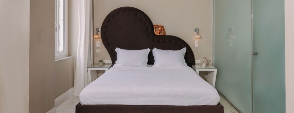 Superior double room with a brown heart shaped headboard